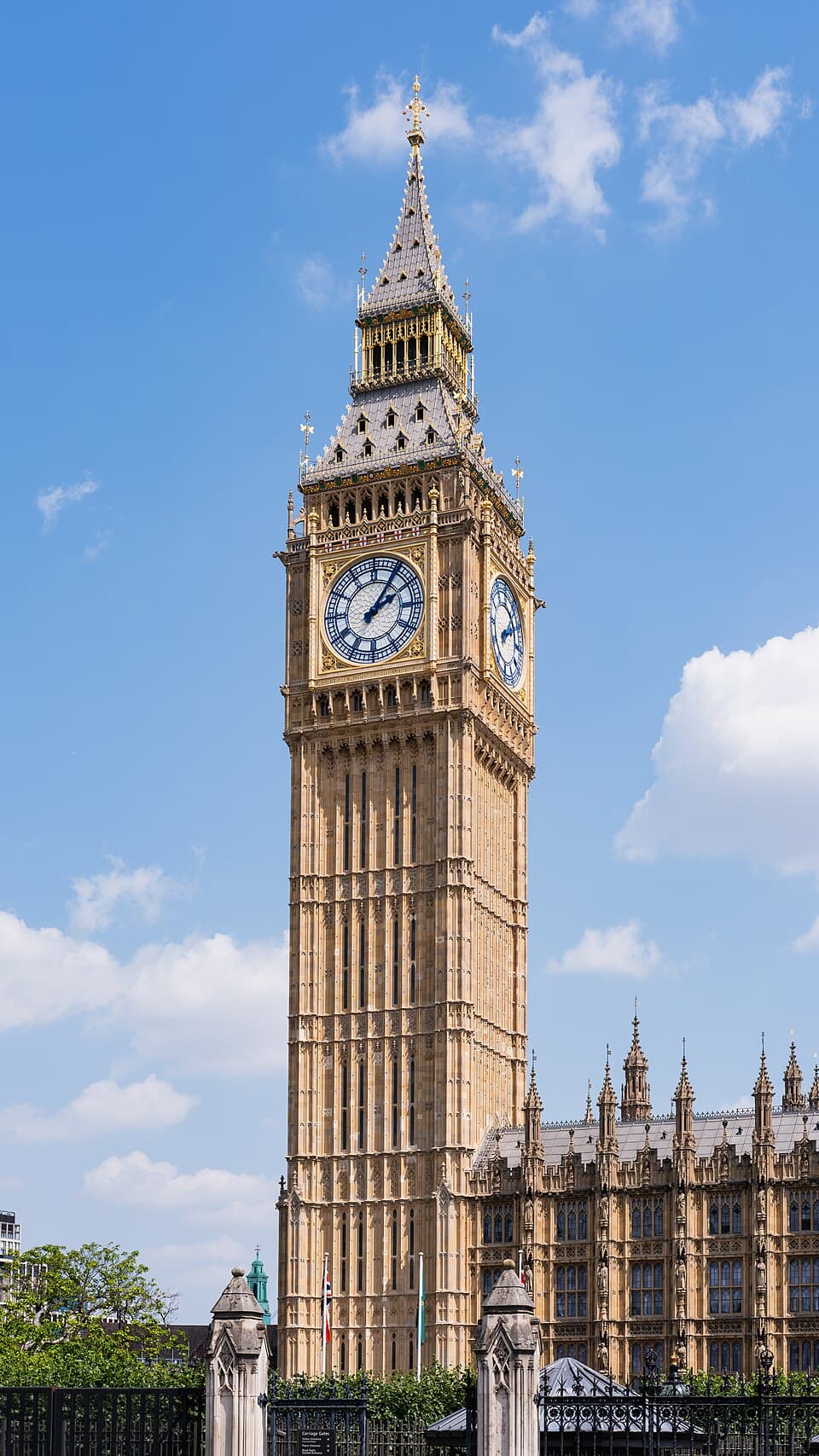 The Elizabeth Tower and the northern end of the Palace of Westminster, seen from Parliament Square near the Carriage Gates. London, England.
